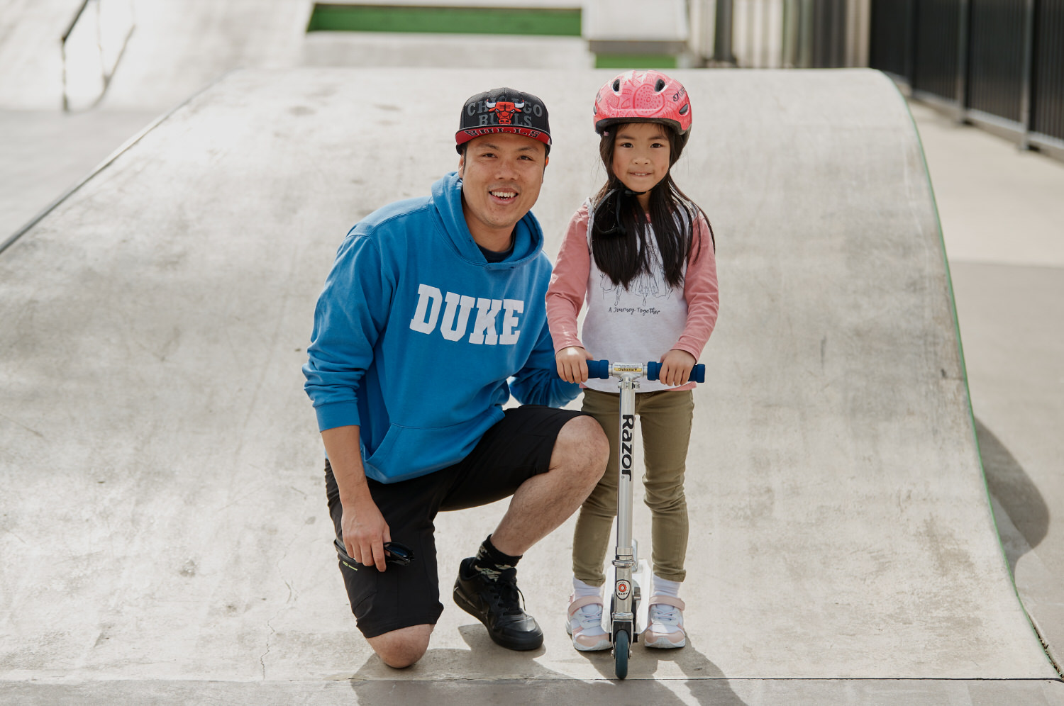 Father and daughter at skate park
