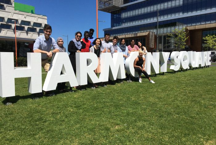 Taskforce standing with Harmony Square letters