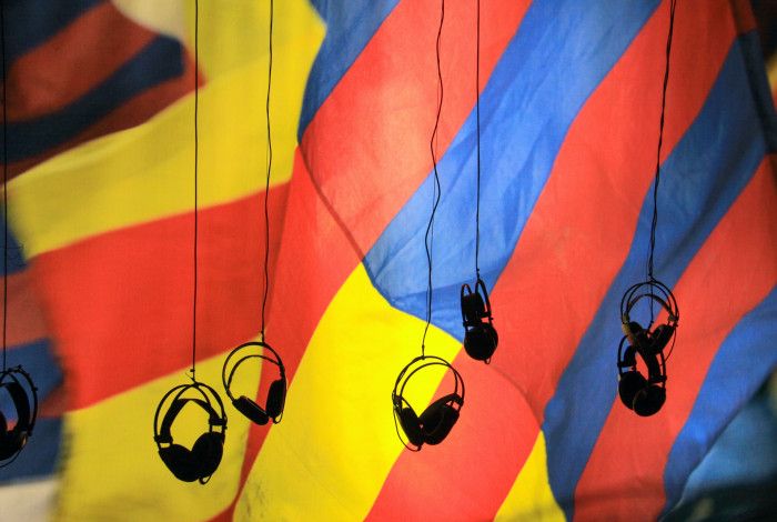 head sets hanging in front of a coloured wall