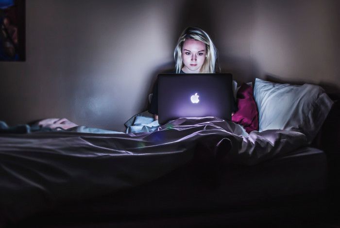 youth in bed on laptop
