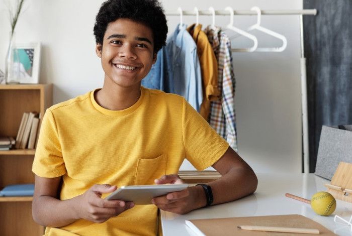 Young man smiling with iPad