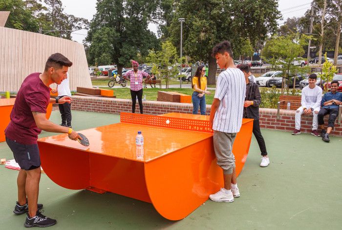 group of young people playing table tennis