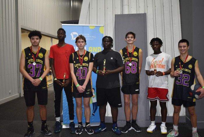 Basketball team holding trophies. 