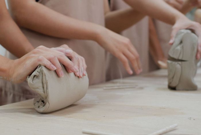 people molding clay