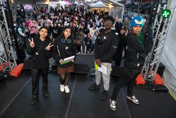 A group of FReeZA young people standing on stage