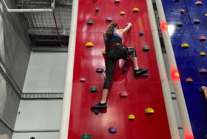 young person rock climbing