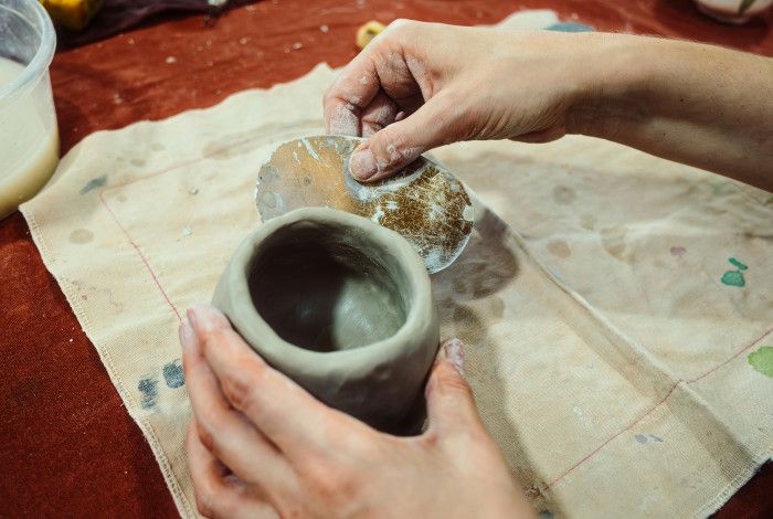 person moulding clay