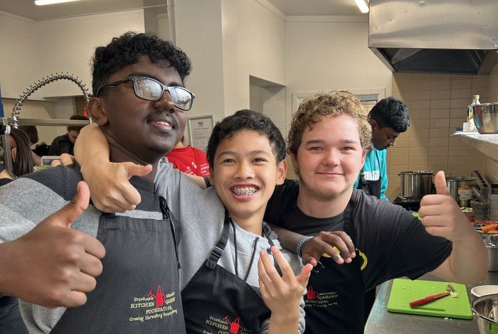 young people smiling in kitchen