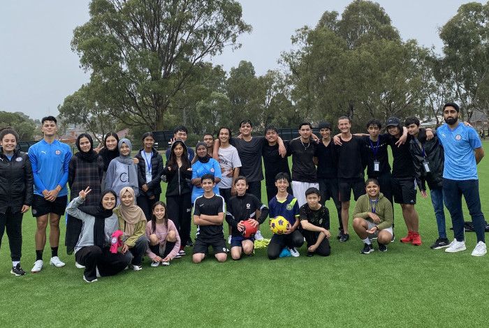 young people smiling on soccer pitch