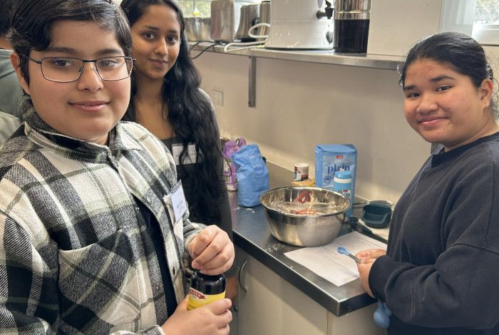 young people smiling in kitchen
