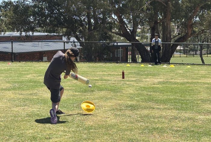 Young person playing cricket
