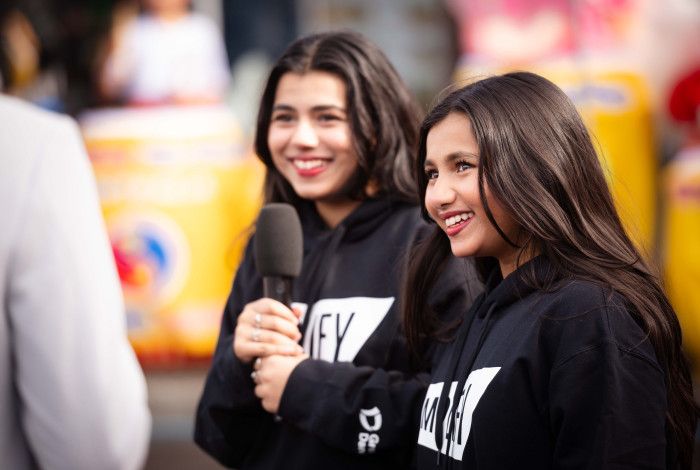 Two young people interviewing someone