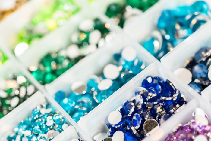 different coloured jewels in container