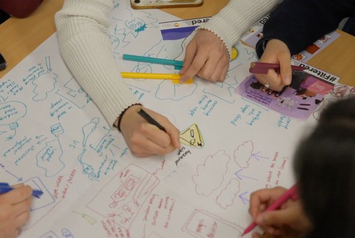 People's hand that are writing on paper