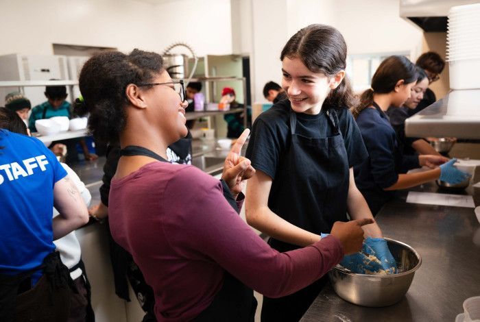two young people laughing and baking