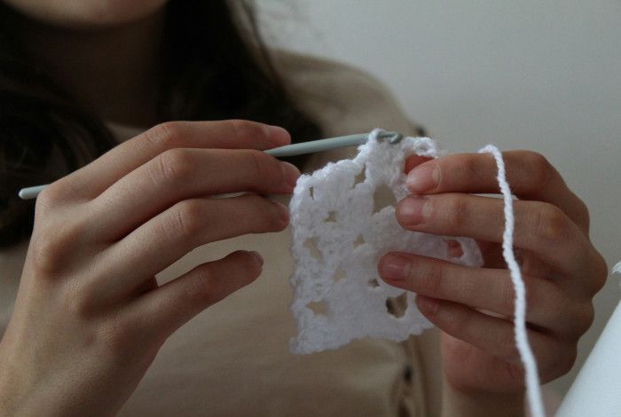 young person doing crochet