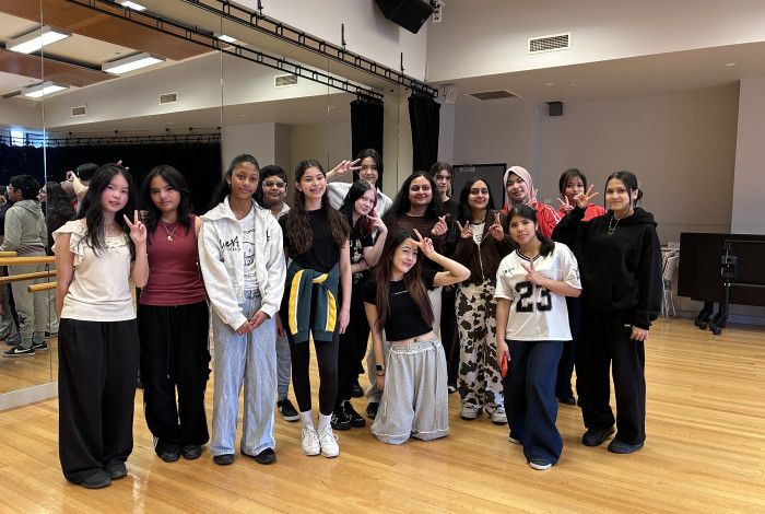 group of young people posing for a picture after movement workshop