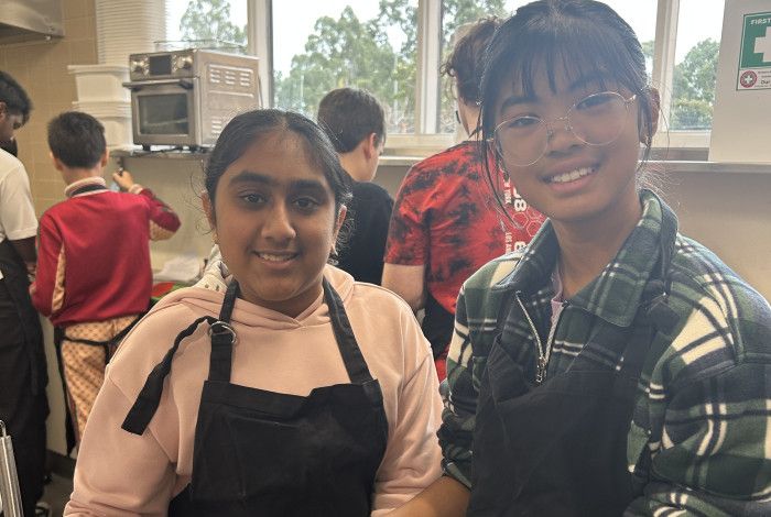 two young people smiling in kitchen