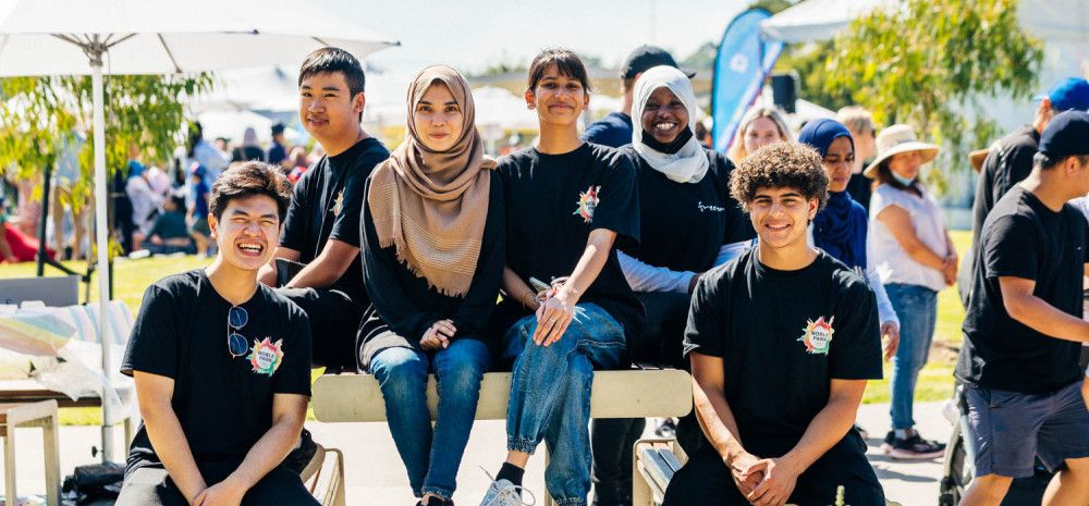 Youth committee members smiling at community festival