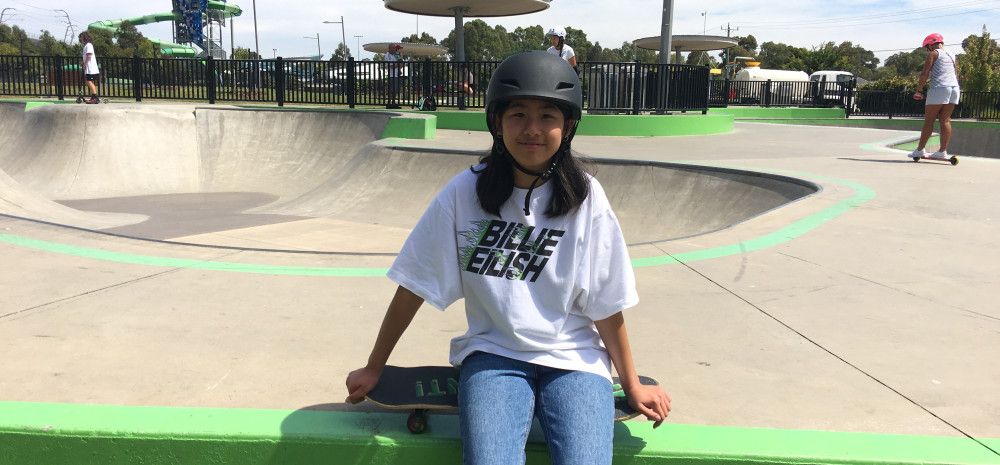 young person siting on a bench at skate park