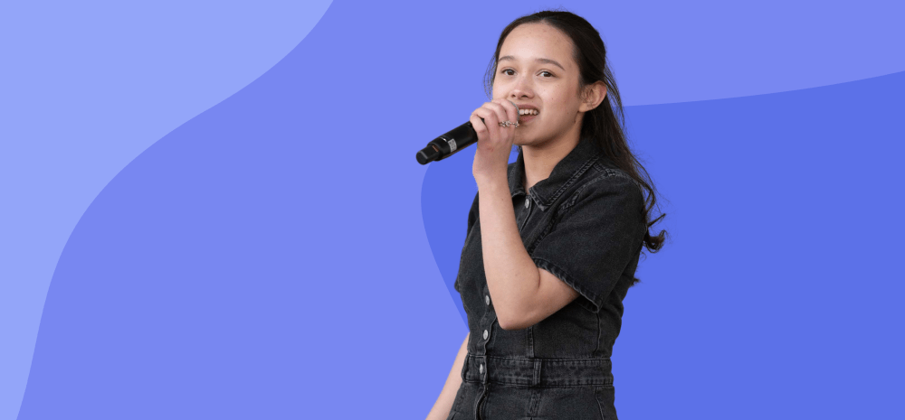 young person singing with a purple background