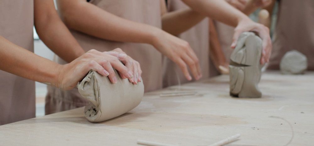 people molding clay