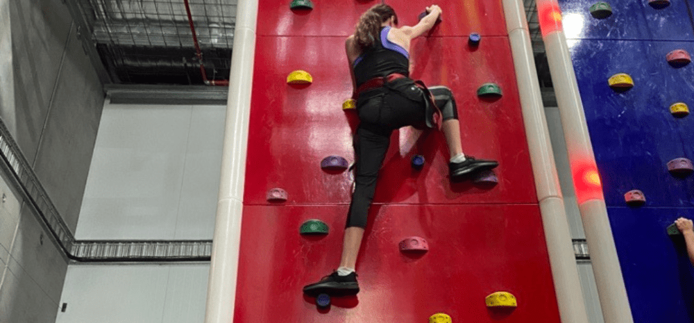 young person rock climbing