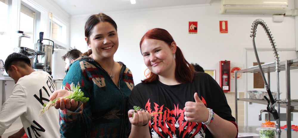 two young people cooking