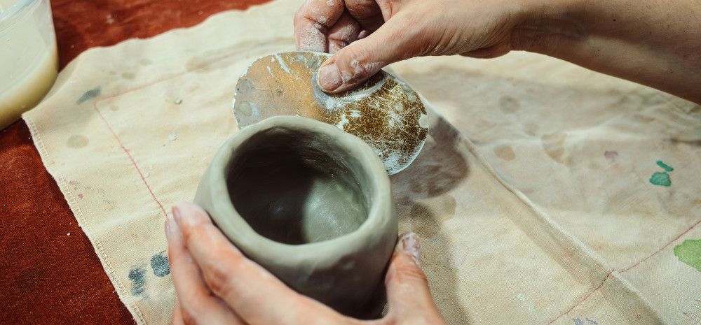 person moulding clay