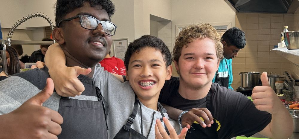 young people smiling in kitchen