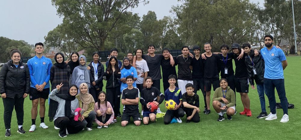 young people smiling on soccer pitch