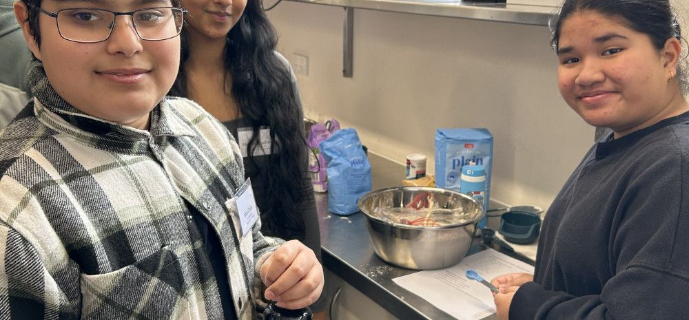young people smiling in kitchen