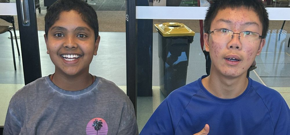 Young people smiling with artwork