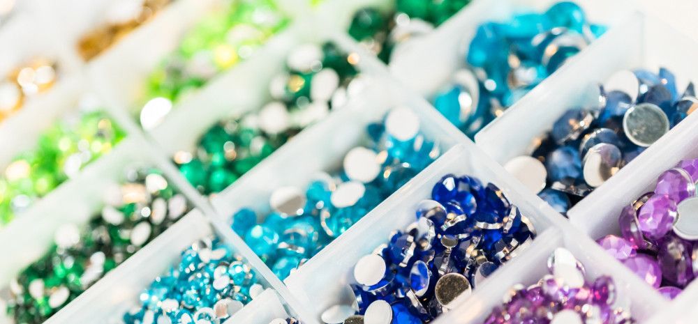 different coloured jewels in container