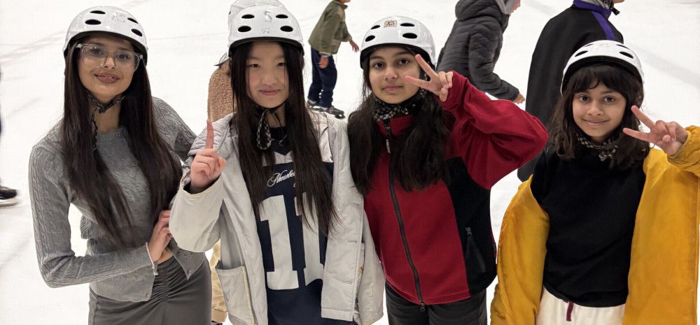 group of young people smiling at ice skating