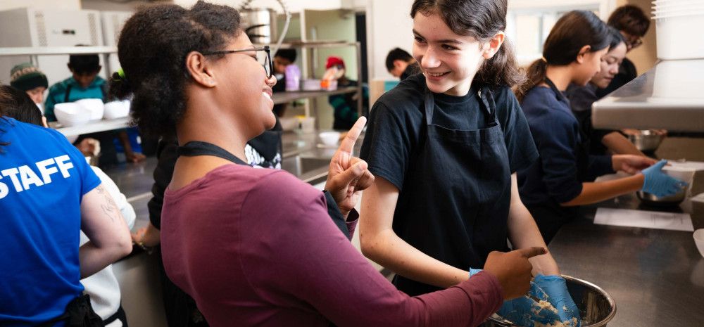two young people laughing and baking