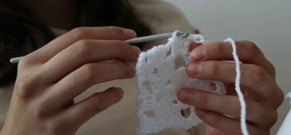 young person doing crochet