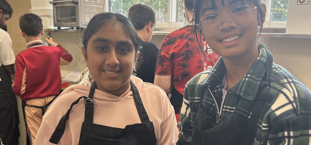 two young people smiling in kitchen