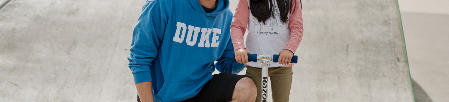 Father and daughter at skate park