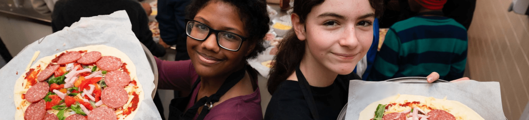 two young people holiday pizzas